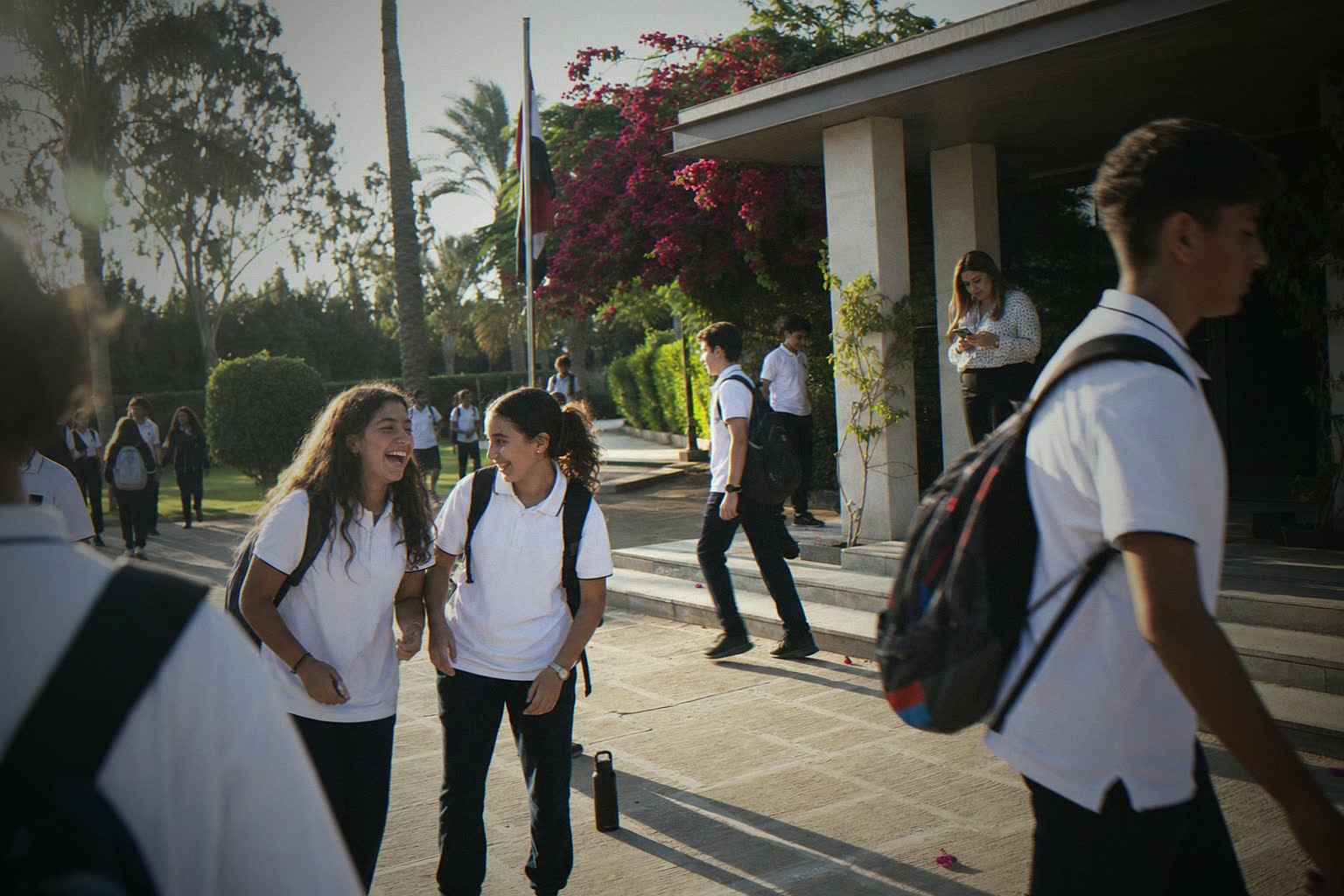 A school entrance on a school morning, students walking in